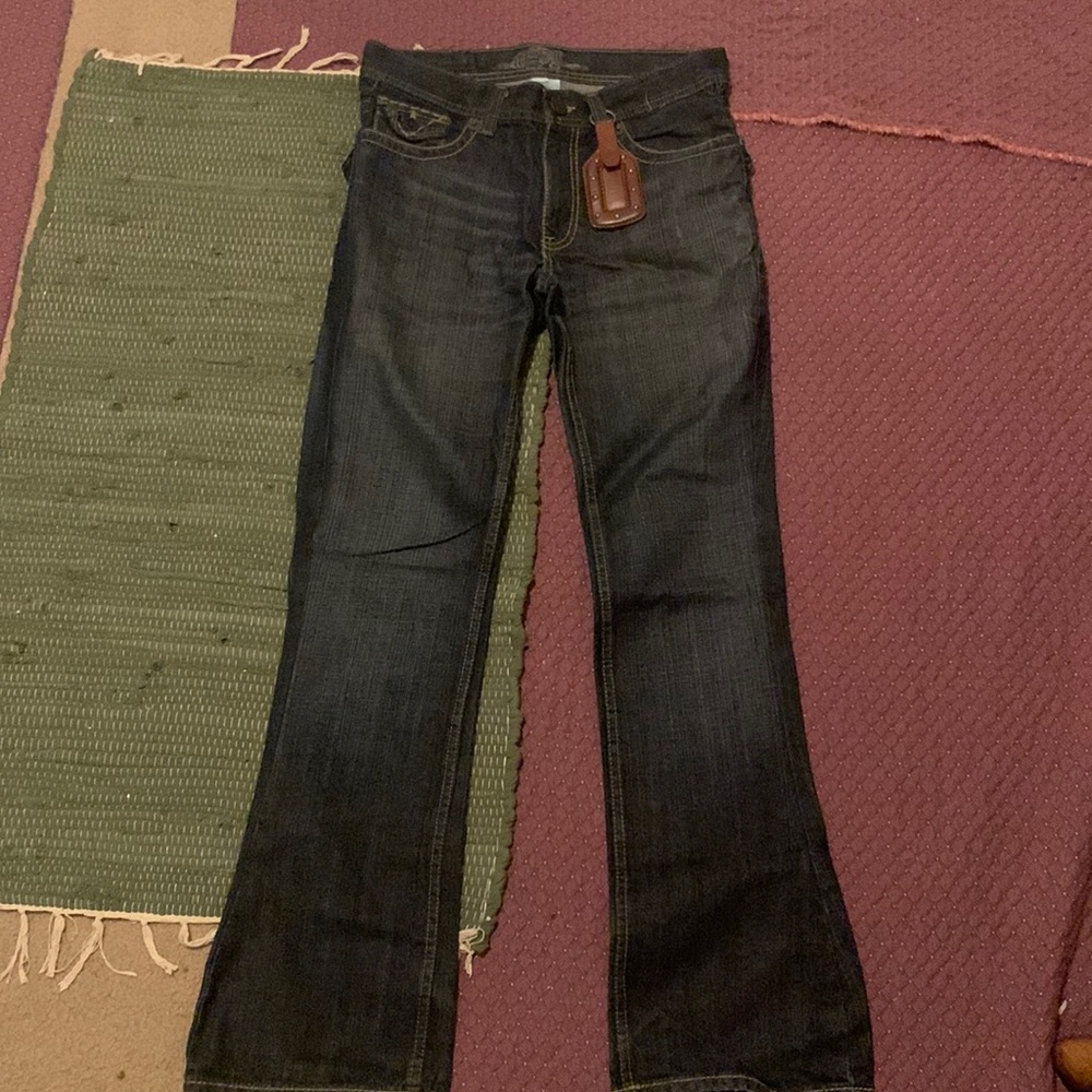 Jeans that have been altered and customized with leather tag!